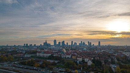Fototapeta na wymiar Warsaw at sunset. The capital of Poland is illuminated by a beautiful orange sun. Panorama of Old Town and downtown
