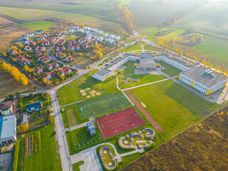 Aerial view of small european town with sradium and sport field, panorama