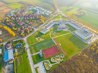Aerial view of small european town with sradium and sport field, panorama