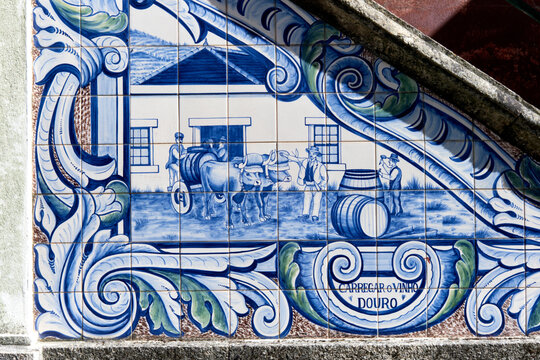 panels of azulejos, tiles, showing the transport of barrels by boat on the railway station of Peso da Regua, Portugal