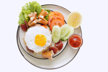 Fried rice and hot dogs, cooked fried egg, Chinese sausage and ketchup on a white background.