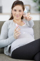 pregnant woman belly with baby bottle