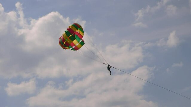 Unidentified person on parasailing parachutes with blue sky landscape view, Pattaya, Thailand