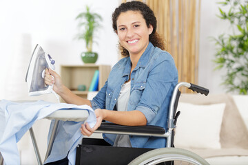 Obraz premium happy disable woman ironing at home