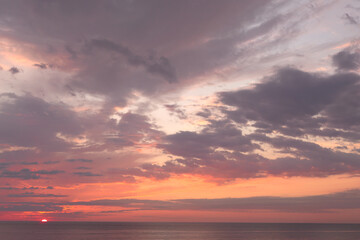 Beautiful sunset sky with pink cloud on the sea.