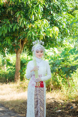 Amazing smiling wedding couple. Wedding day bride in wedding dress. Indonesian bride. Beautiful bride Beautiful bride and groom in outdoor.