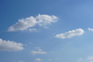 Blue sky with fluffy white clouds constantly changing shape.