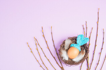 Easter bunny or rabbit in a bird nest, made from an egg and crocheted ears, spring holiday,...