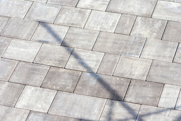 Gray paving stones. Paving surface road. Texture made of big gray cement bricks. Brick stone street...