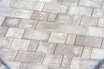 Gray paving stones. Paving surface road. Texture made of big gray cement bricks. Brick stone street...