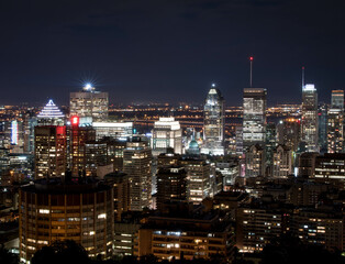 Fototapeta na wymiar Montreal at night.Montreal panorama viewed from the Mount Royal.Night view of Montreal skyline with tall skyscrapers and busy street