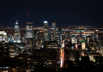 Fototapeta na wymiar Montreal at night.Montreal panorama viewed from the Mount Royal.Night view of Montreal skyline with tall skyscrapers and busy street