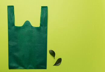 Plastic and biodegradable bag on color background, top view