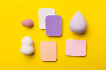 Beauty blenders on color background, top view