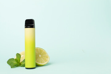 Disposable electronic cigarette and fruit on color background