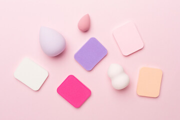 Beauty blenders on color background, top view