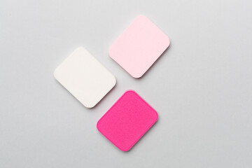 Beauty blenders on color background, top view