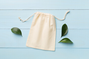 Small eco sack on wooden background. Top view.