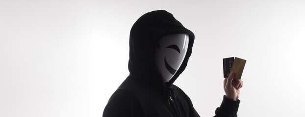 Hacker man and credit cards in hand. Represent credit cards personal data stolen by anonymous man...