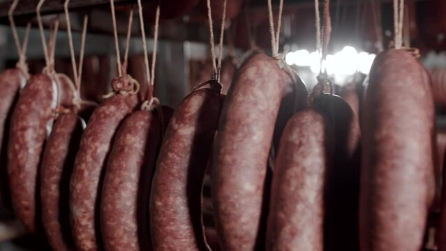 Smoked sausage in the smoke house, Food industrial. Sausage processing line food industry.