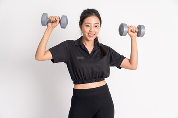 woman smiling while lifting dumbbells exercising shoulder muscles on white background