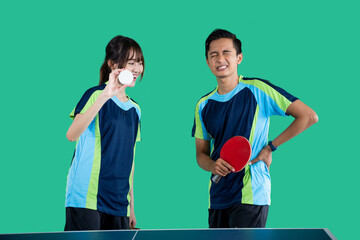 male athlete with sore hip muscles with a female athlete holding medicine on a green screen background