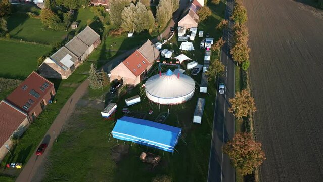 Round white two master tent. Beautiful aerial view flight panorama orbit drone
brandenburg circus tent golden houre 2022. 4k marnitz Cinematic