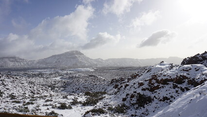 Teide National Park in snow on a sunny December day, volcanic mountains covered with snow