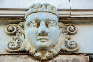 A sculpted mascaron ornament above a door on a historic building in Natchez, Adams County,...