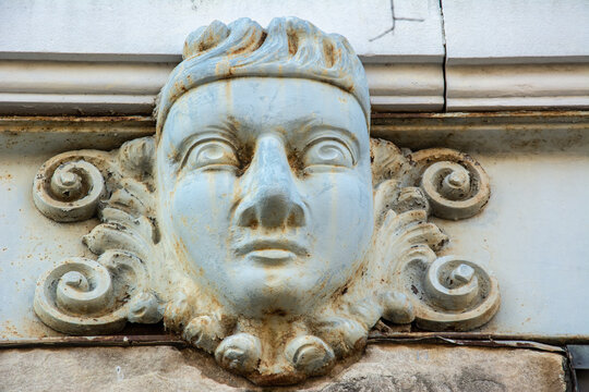 A sculpted mascaron ornament above a door on a historic building in Natchez, Adams County, Mississippi, USA