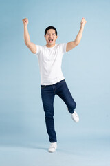 portrait of asian man posing on blue background