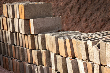 Several building blocks (bricks) stacked under sunlight