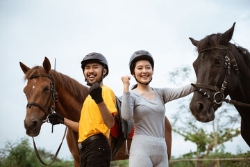 two equestrian athletes ride horses and start training in outdoor background