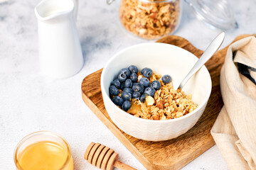 Homemade granola with nuts and fresh blueberries for breakfast. Healthy breakfast. Vegetarian food concept