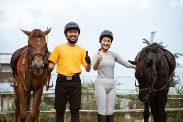 Fototapeta premium two equestrian athletes ride horses and start training in outdoor background
