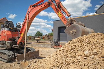 Excavator at the construction of a new house, during earthworks. © jarizPJ