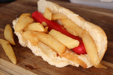 Vienna and chips hot dog. South African traditional fast food Vienna and chips parcel 