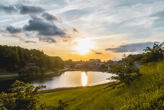 Sunset evening view over lake in green meadow
