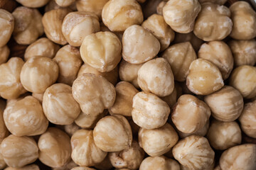 A pile of peeled hazelnuts as a textured background. Healthy nutrition concept