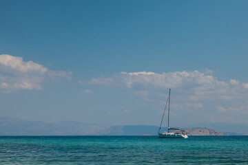 Fototapeta premium White sailing yacht on Mediterranean Sea next to greek islands