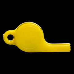 Tiny Yellow Plastic Whistle, Macro Photo on a black background.