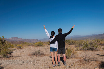 a couple overlooking a desert landscape