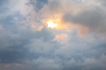 Sunset sun between clouds