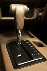 Automatic gear stick inside modern brown leather car. Luxury and expensive concept.