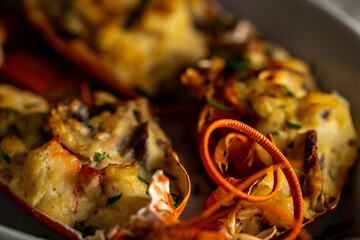 Lobster thermidor, a classic lobster dish in which a cooked lobster is halved down middle. The meat...