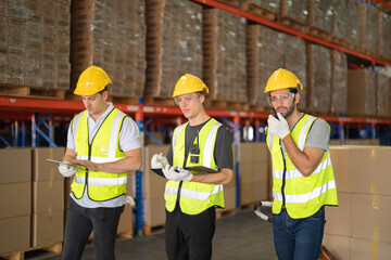 Teamwork of workers working in large warehouse retail store industry.Rack of stock storage. Interior of cargo in ecommerce and logistic concept. Depot. People lifestyle. Shipment service for container