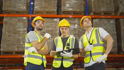 Teamwork of workers working in large warehouse retail store industry.Rack of stock storage. Interior of cargo in ecommerce and logistic concept. Depot. People lifestyle. Shipment service for container