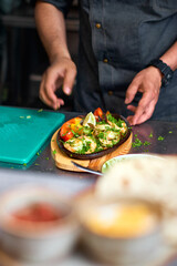 Traditional Mexican beef fajitas on fire in the kitchen, also called alambre