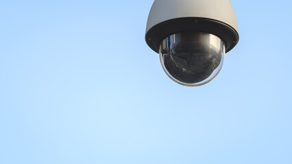 Closeup of outdoor dome type surveillance CCTV isolated with blue sky background. Public security camera monitoring system and crime protection concept.