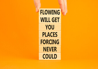 Flowing symbol. Concept words Flowing will get you places forcing never could on wooden blocks....